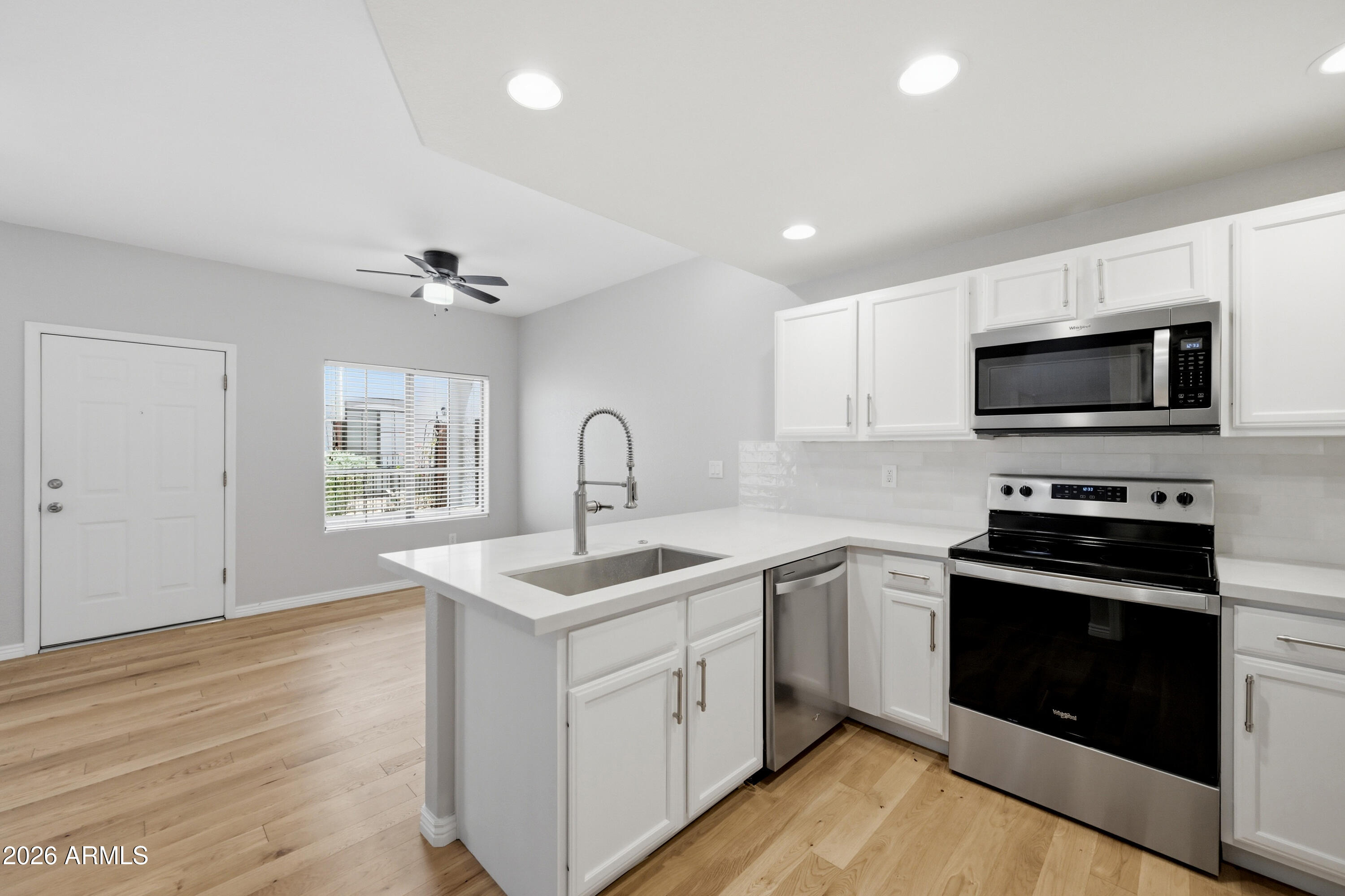 3150 East Beardsley Road, Unit 1009 Phoenix, AZ 85050 - Photo 11 of 31 a kitchen with a sink stove and microwave