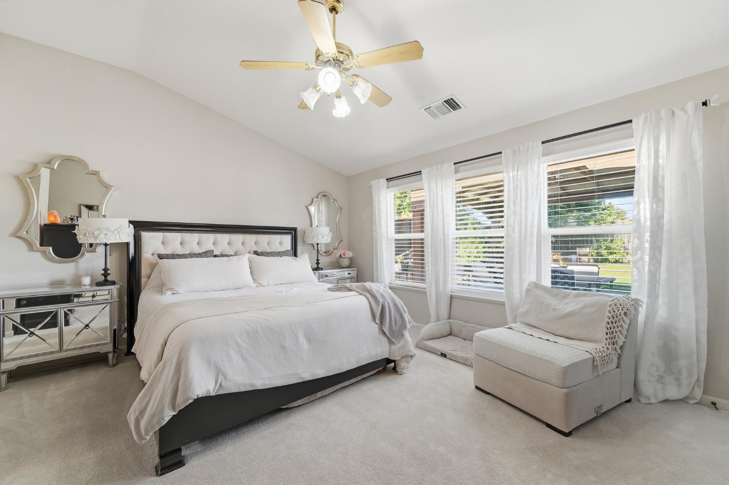 2220 Ellison Drive Modesto, CA 95355 - Photo 22 of 53 a bedroom with a large bed and a chandelier