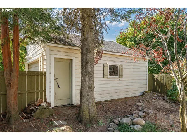 a view of backyard of house and trees