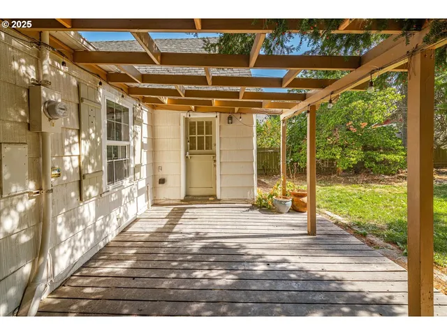 a view of a room with wooden floor and windows