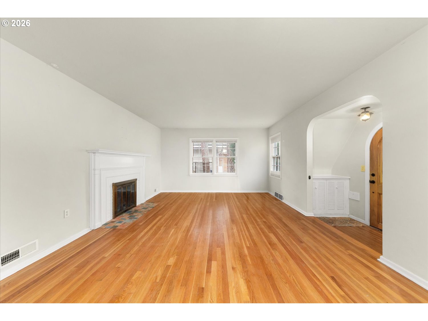 1118 East 28th Avenue Spokane, WA 99203 - Photo 36 of 48 a view of empty room with window and wooden floor