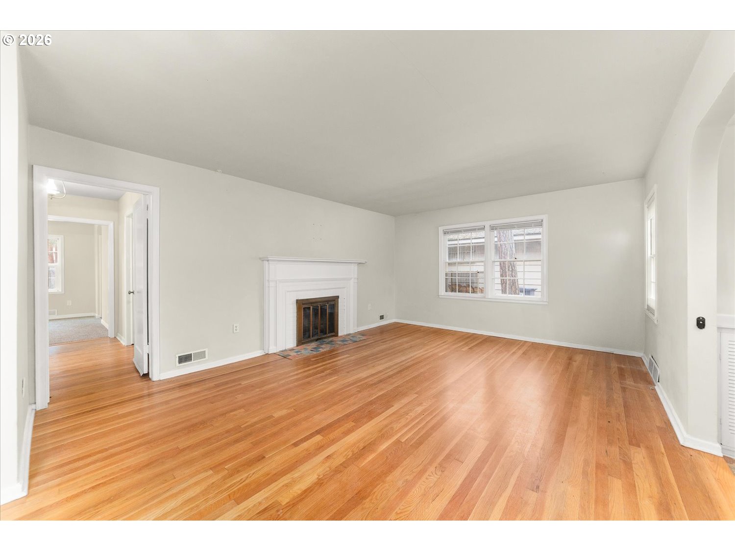 1118 East 28th Avenue Spokane, WA 99203 - Photo 39 of 48 a view of an empty room with wooden floor and a window