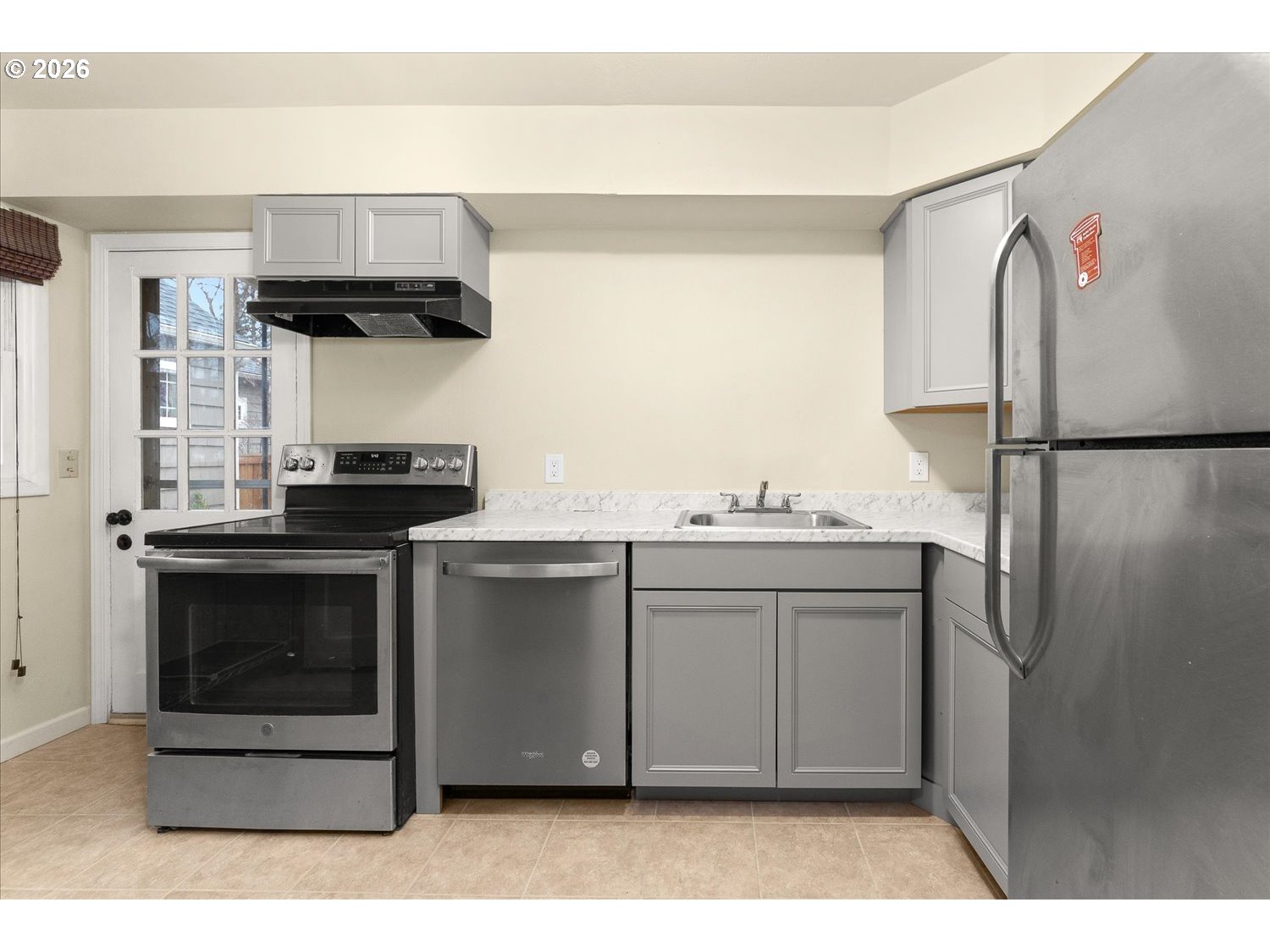 1118 East 28th Avenue Spokane, WA 99203 - Photo 42 of 48 a kitchen with stainless steel appliances a stove and a refrigerator