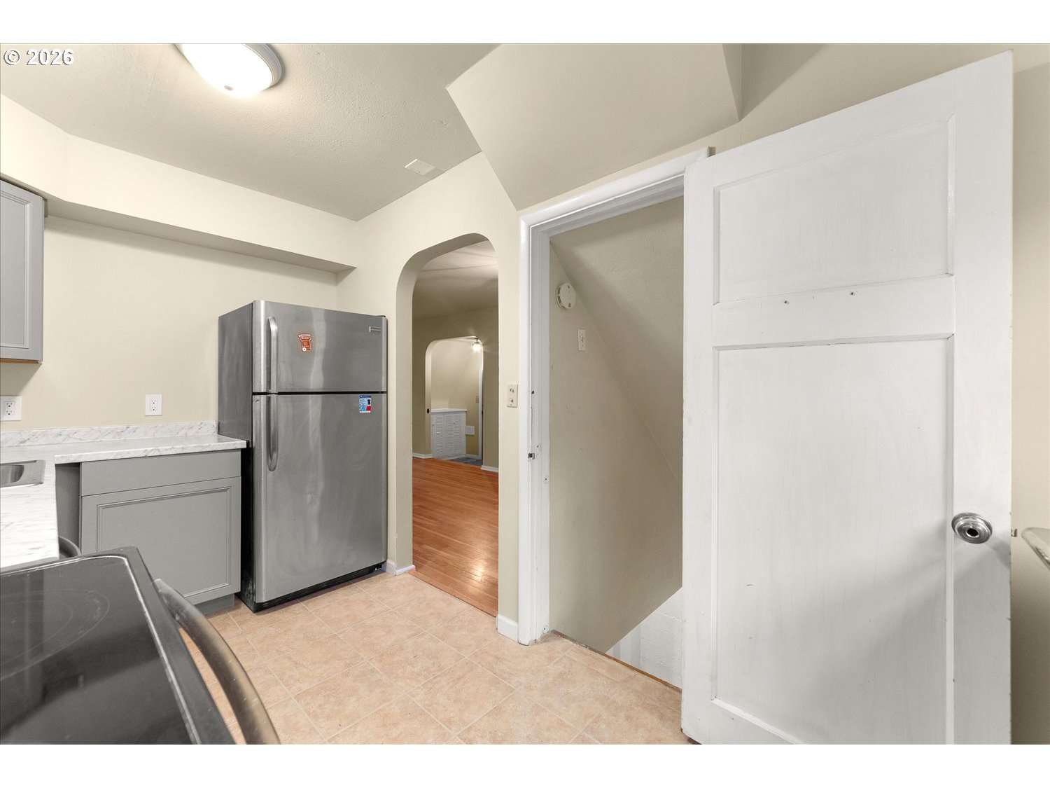 1118 East 28th Avenue Spokane, WA 99203 - Photo 46 of 48 a kitchen with refrigerator cabinets and wooden floor