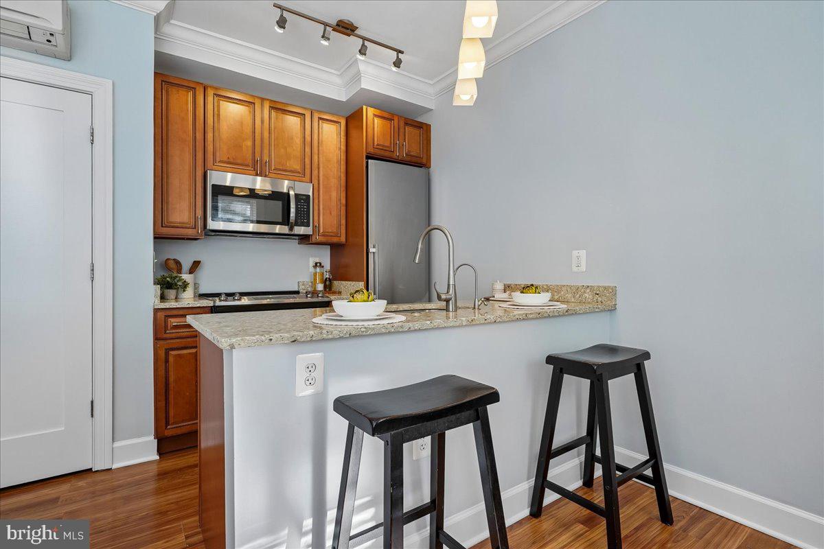 1121 24th Street Northwest, Unit 309 Washington, DC 20037 - Photo 11 of 20 a kitchen with stainless steel appliances a sink and a refrigerator