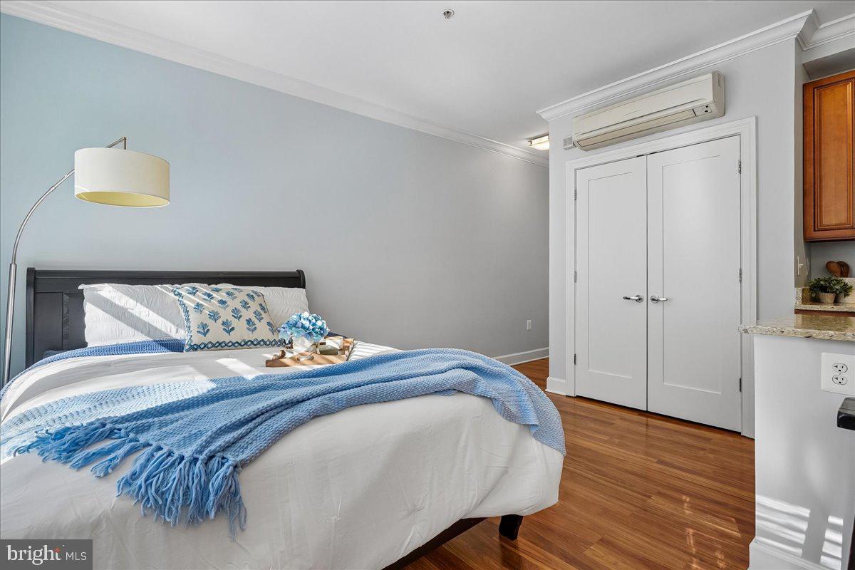 1121 24th Street Northwest, Unit 309 Washington, DC 20037 - Photo 16 of 20 a bedroom with a bed and a table in it