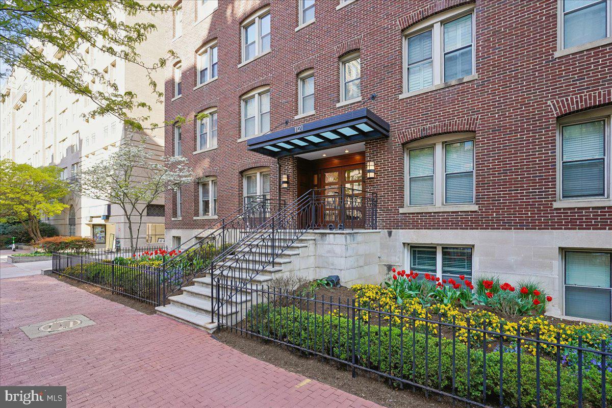 1121 24th Street Northwest, Unit 309 Washington, DC 20037 - Photo 19 of 20 a front view of a multi story residential apartment building