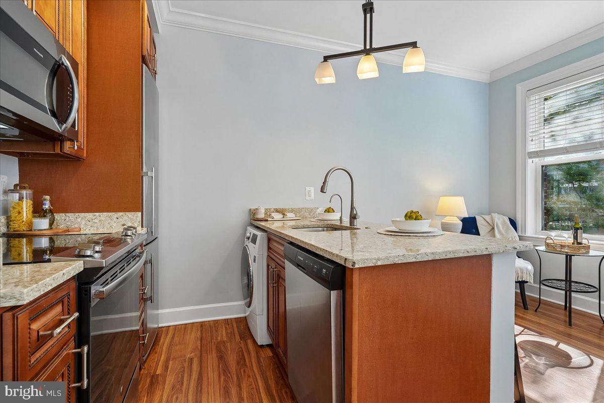 1121 24th Street Northwest, Unit 309 Washington, DC 20037 - Photo 8 of 20 a kitchen with a sink a stove and cabinets