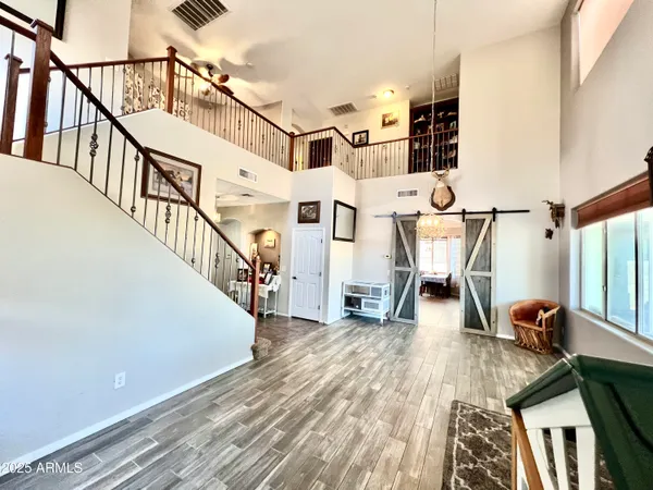 a view of entryway and hall with wooden floor