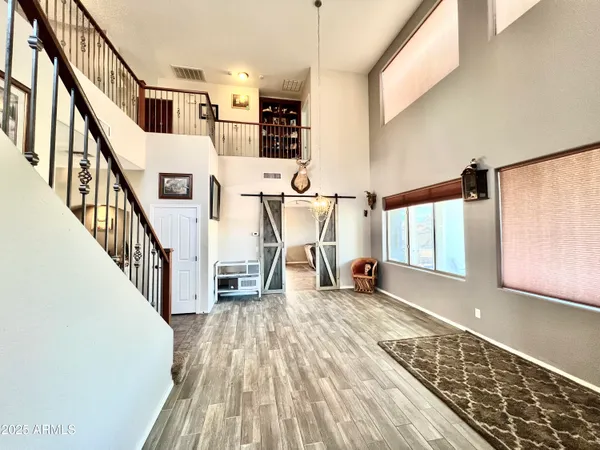 a view of entryway and hall with wooden floor