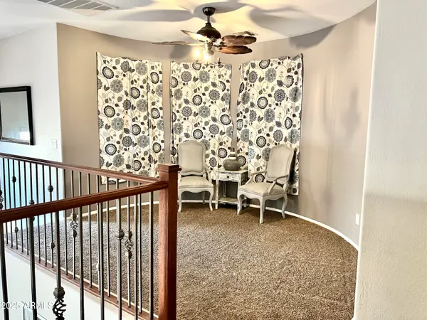 a view of a chairs and table in a balcony