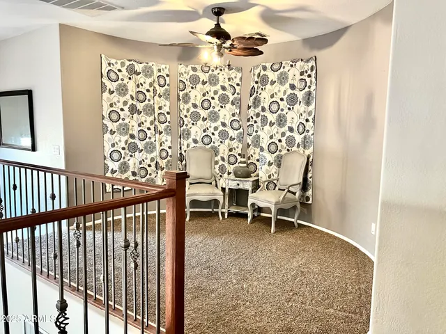 a view of a chairs and table in a balcony