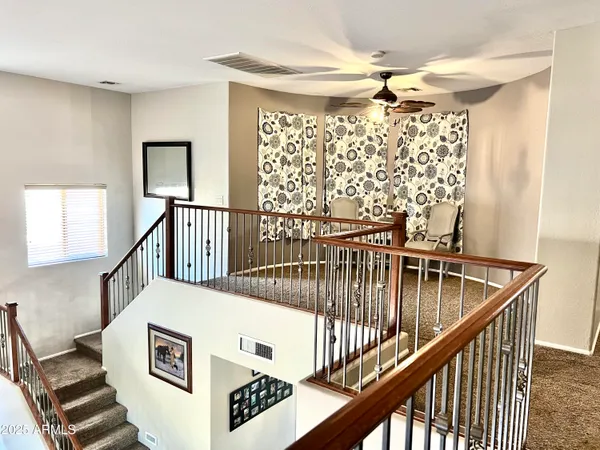 a view of staircase with furniture and a window