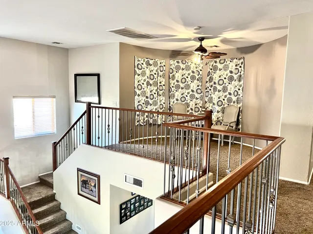 a view of staircase with furniture and a window