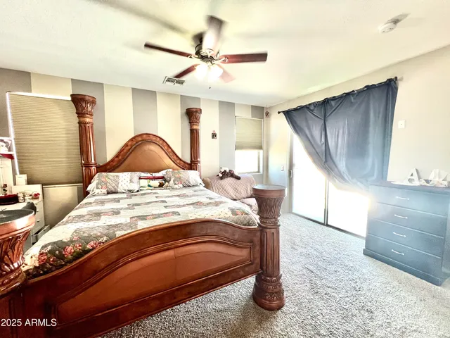 a bedroom with a bed a window and a mirror