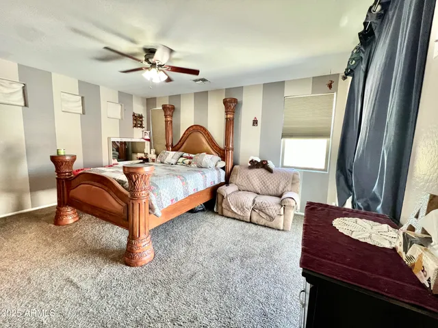 a bedroom with bed and a chandelier