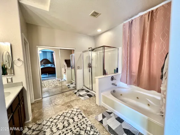 a bathroom with a tub sink and mirror