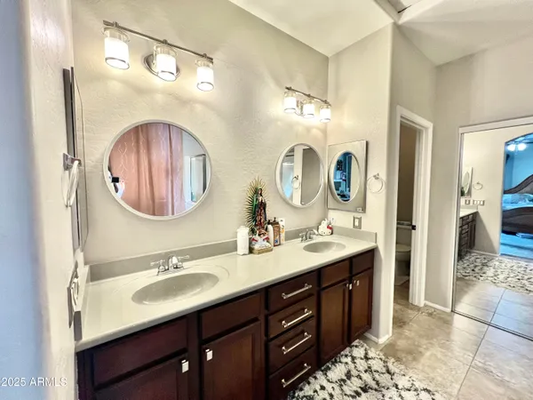 a bathroom with a double vanity sink and a mirror