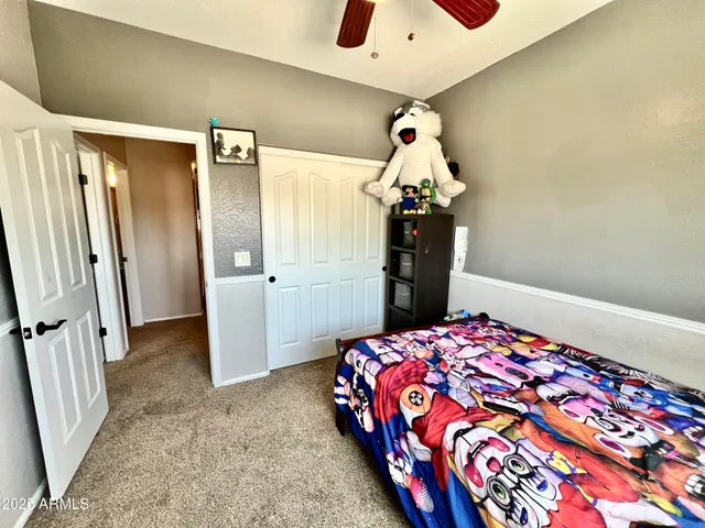 a bedroom with a bed and a dresser