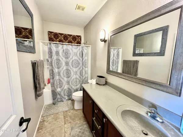 a bathroom with double vanity sink and a mirror