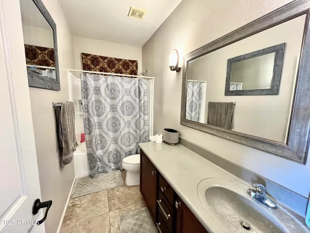 a bathroom with double vanity sink and a mirror