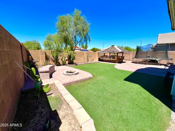 a view of a backyard with sitting area