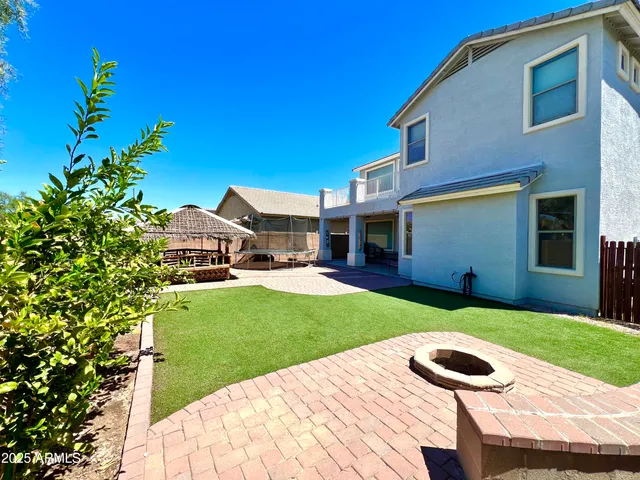 a view of a house with a yard and sitting area