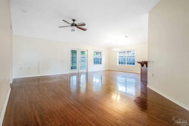 a kitchen with granite countertop a sink window and cabinets