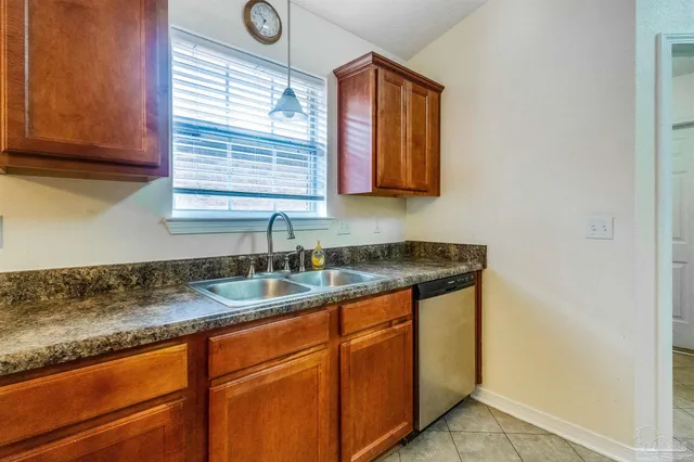 a view of a backyard with a tub and wooden fence