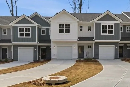 a view of a house with a yard and garage