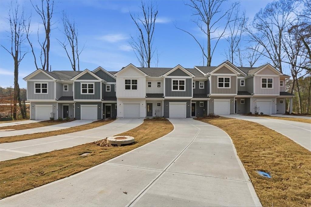 51 Wright Street, Unit 66 Lavonia, GA 30553 - Photo 2 of 47 a front view of a house with a yard covered with snow in front of house
