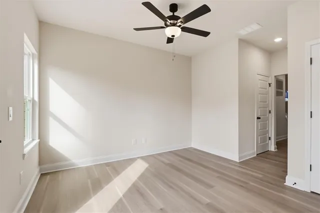 a view of a hallway with a ceiling fan