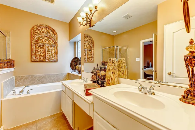 a bathroom with a tub sink and mirror