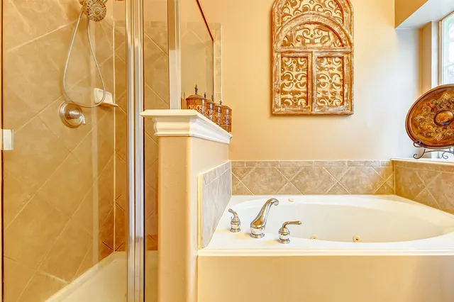 a bathroom with a tub and shower