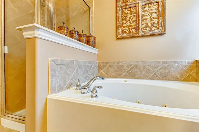 a bathroom with a bathtub and a shower