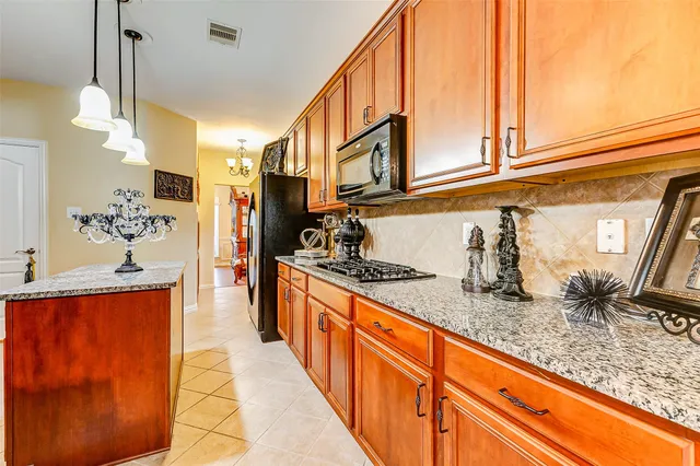 a kitchen with stainless steel appliances granite countertop a sink and cabinets