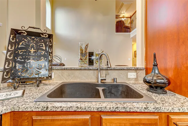 a kitchen sink with granite countertop a sink and a granite counter top