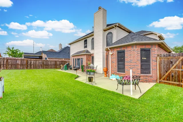 a view of a house with a yard and sitting area