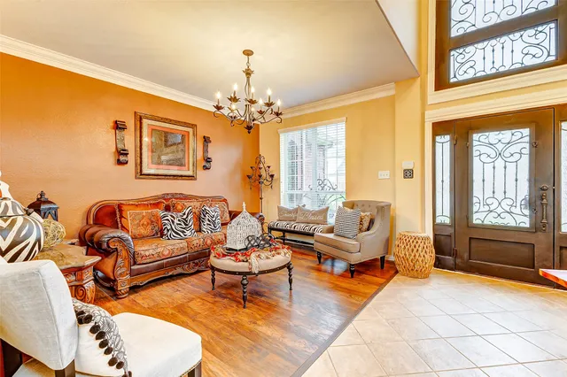 a living room with furniture and a chandelier