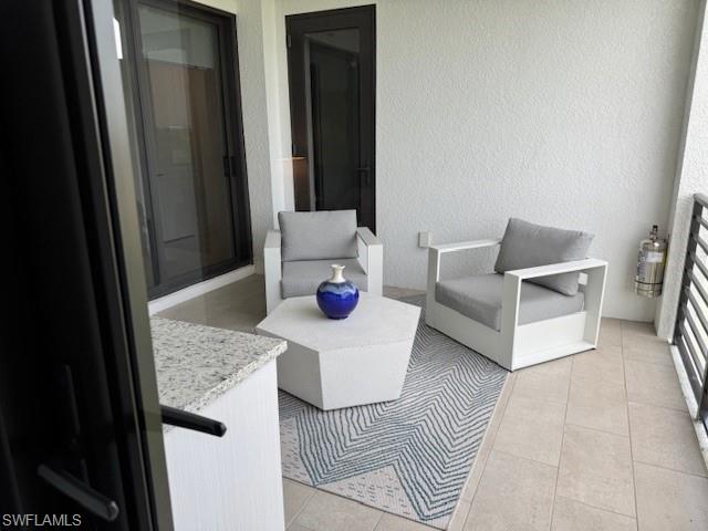 1125 Central Avenue, Unit 461 Naples, FL 34102 - Photo 15 of 19 a living room with furniture and white wooden floor