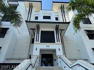 1125 Central Avenue, Unit 461 Naples, FL 34102 - Photo 2 of 19 a view of living room with furniture and a fireplace