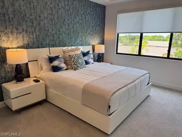 1125 Central Avenue, Unit 461 Naples, FL 34102 - Photo 7 of 19 a bed sitting in a bedroom next to a window