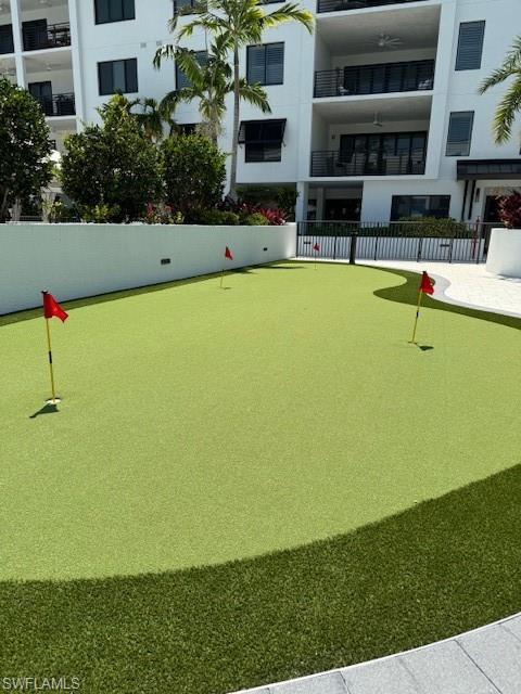 1125 Central Avenue, Unit 461 Naples, FL 34102 - Photo 8 of 19 a view of a swimming pool with a lawn chairs under an umbrella