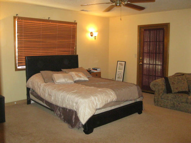 10786 Deschutes Road Palo Cedro, CA 96073 - Photo 11 of 24 a bed sitting in a bedroom next to a window