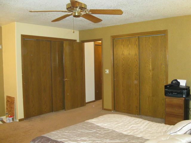 10786 Deschutes Road Palo Cedro, CA 96073 - Photo 13 of 24 a bedroom with a bed and a chandelier