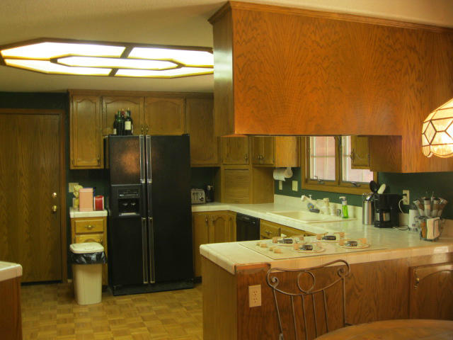 10786 Deschutes Road Palo Cedro, CA 96073 - Photo 6 of 24 a kitchen with a sink and refrigerator