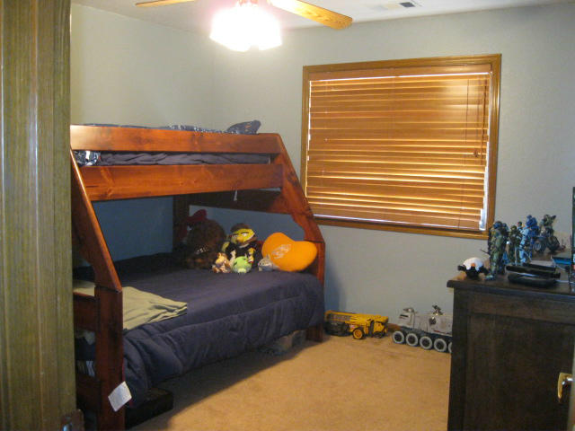 10786 Deschutes Road Palo Cedro, CA 96073 - Photo 10 of 24 a bedroom with a bed and a window