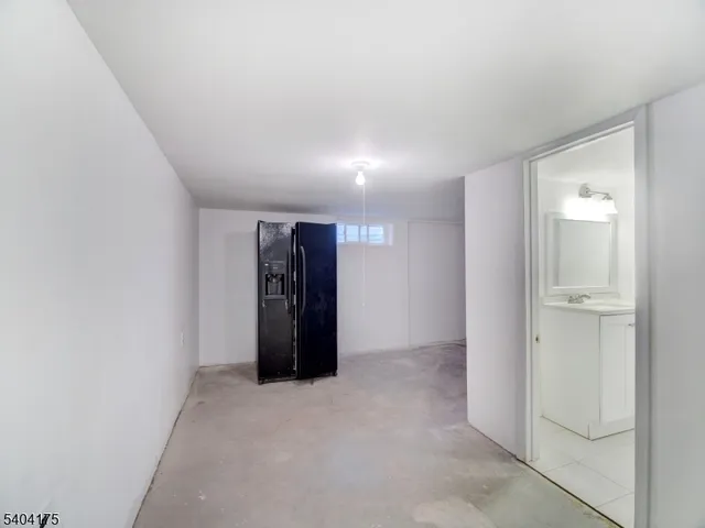 a bedroom with a bed and a dresser with mirror