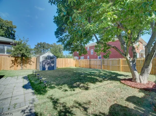 a house that has a big yard with wooden fence