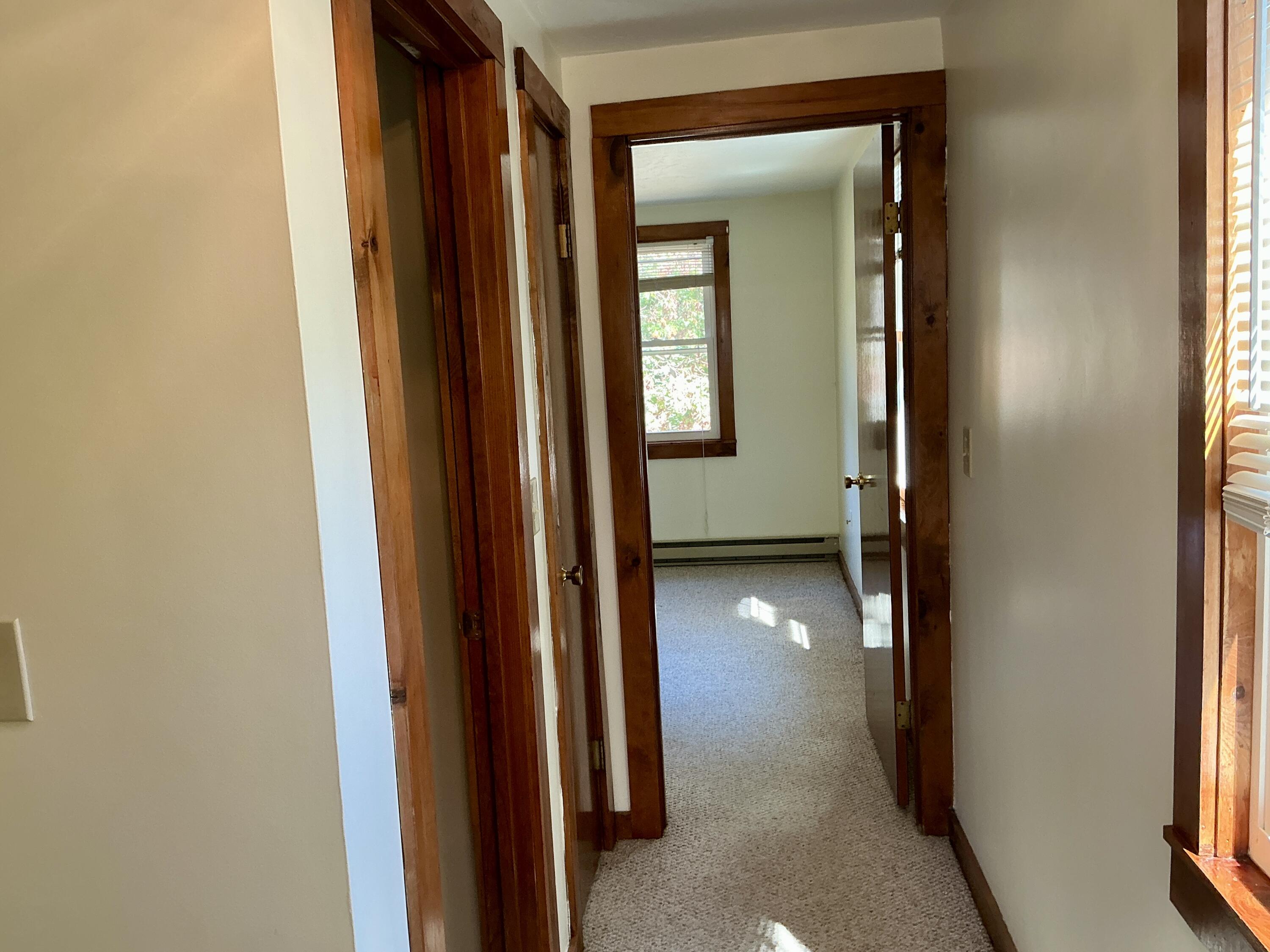 300 Falmouth Road, Unit 7E Mashpee, MA 02649 - Photo 13 of 27 a view of a hallway with windows and a bathroom